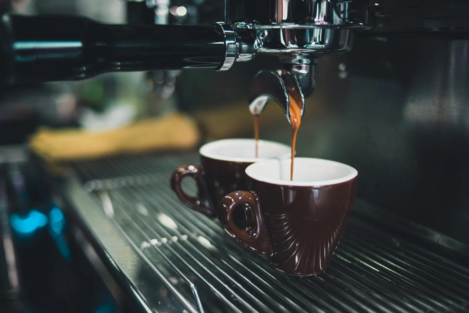 Espresso machine pulling two shots into cups